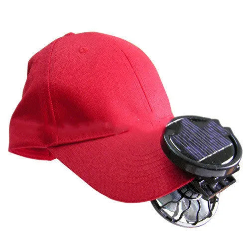 Black portable solar panel fan with a clip, shown outdoors for camping cooling.