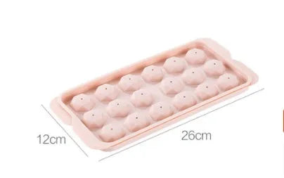 Round ball ice cube moulds in sky blue and pink creating spherical ice for drinks