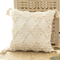 Nordic tufted throw pillow with tassels in beige on a light sofa