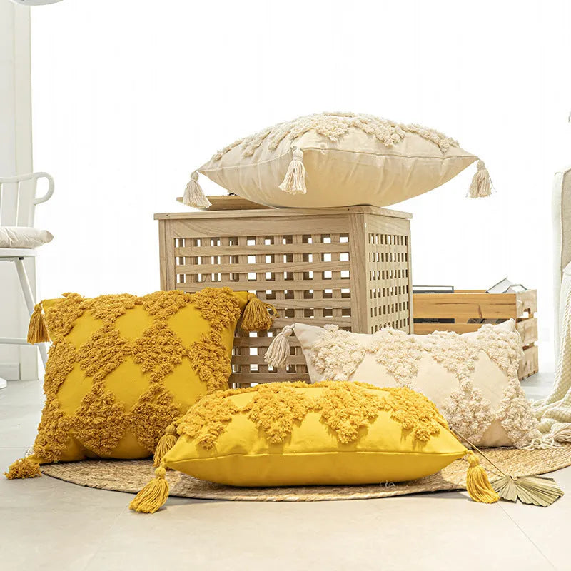 Nordic tufted throw pillow with tassels in beige on a light sofa