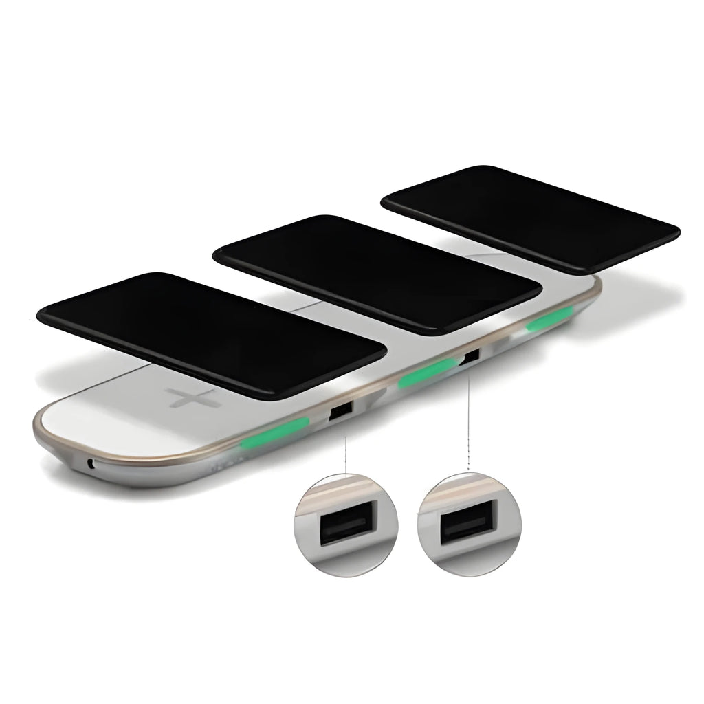 A black universal Qi wireless charging pad on a wooden desk next to a smartphone.