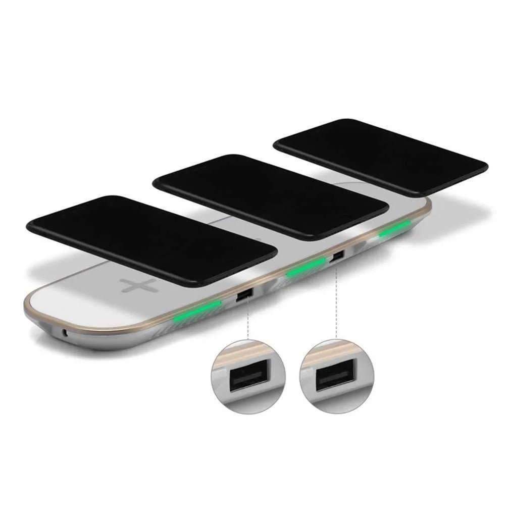 A black universal Qi wireless charging pad on a wooden desk next to a smartphone.