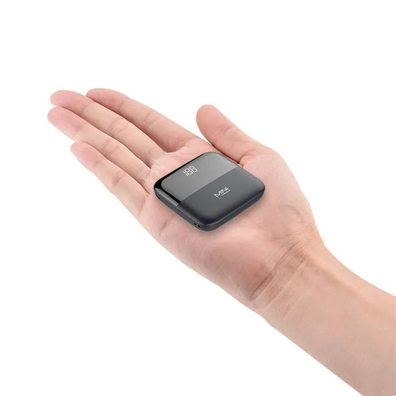 Digital display power bank with LCD screen showing battery level, compact plastic design, available in black