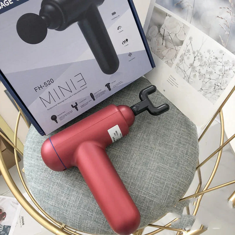 Black, red, and grey coloured handheld fascia massage gun with USB charging port.