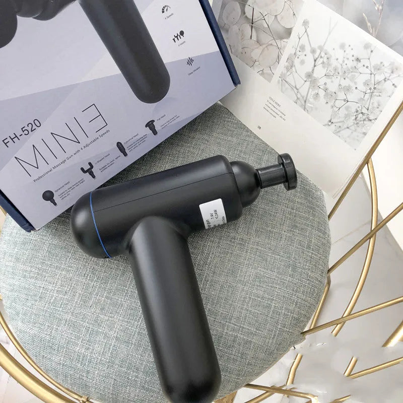 Black, red, and grey coloured handheld fascia massage gun with USB charging port.
