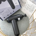 Black, red, and grey coloured handheld fascia massage gun with USB charging port.