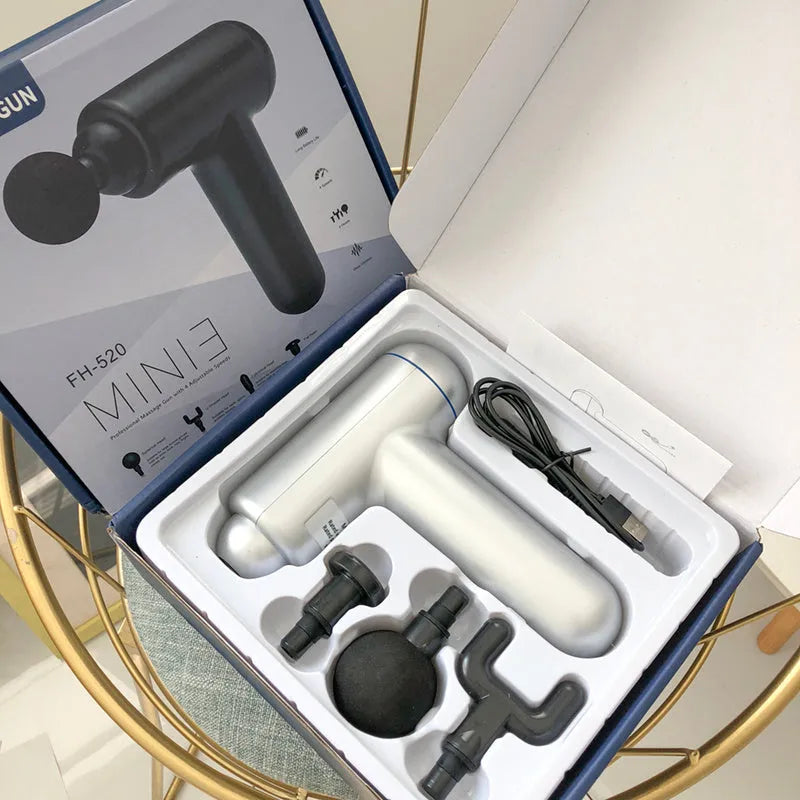 Black, red, and grey coloured handheld fascia massage gun with USB charging port.