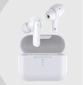 Black and white wireless in-ear Bluetooth headphones with a magnetic charging case on a table.