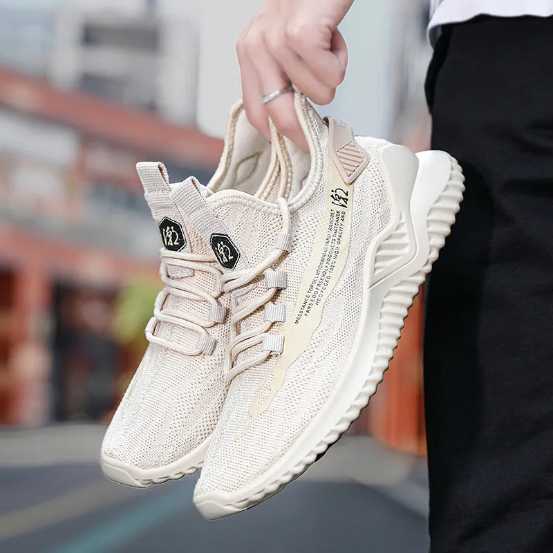 Men's low-top white mesh sports shoes with rubber sole on a plain background
