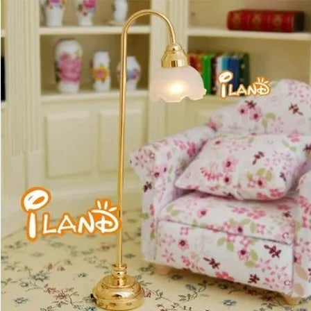 Miniature dollhouse floor lamp with flower-shaped shade and metal base for battery-powered lighting