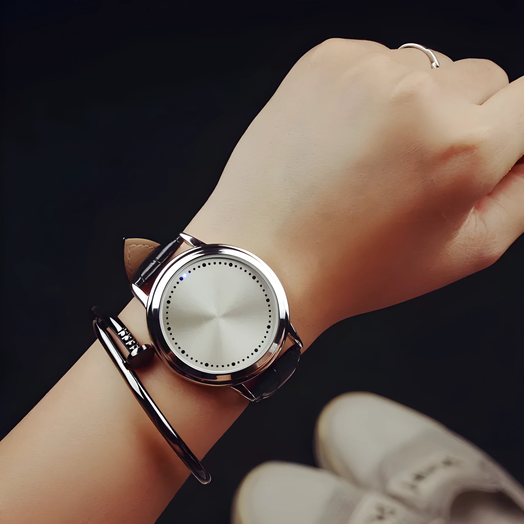 Electronic digital watch with bright blue light display showing time on black or white watch face
