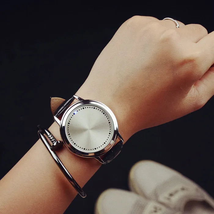 Electronic digital watch with bright blue light display showing time on black or white watch face