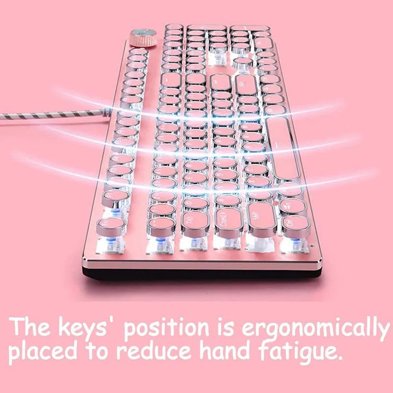 Queen Lipstick mechanical keyboard with silver base, pink keys, green switches, and a wireless mouse on a desk.
