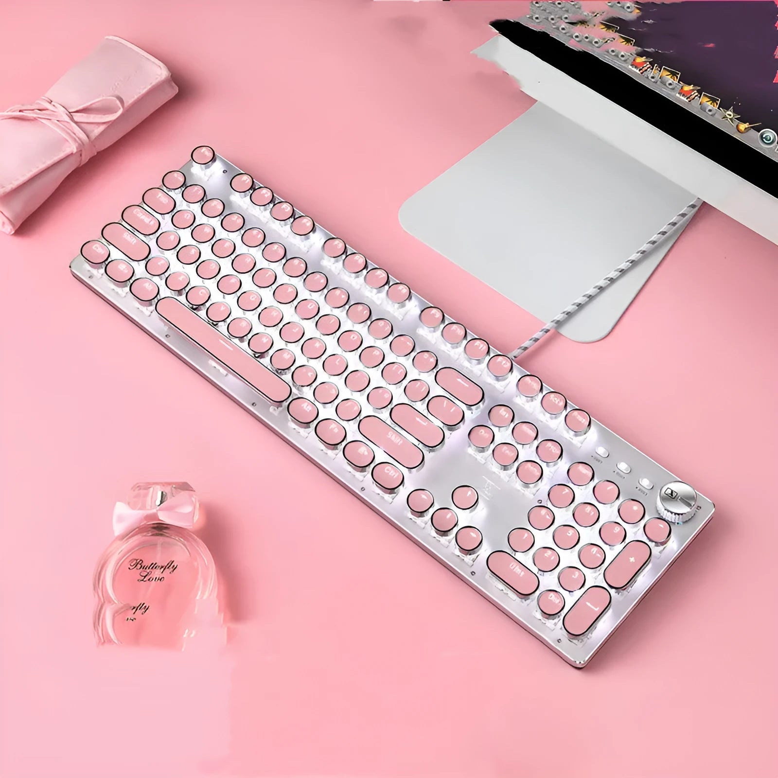 Queen Lipstick mechanical keyboard with silver base, pink keys, green switches, and a wireless mouse on a desk.
