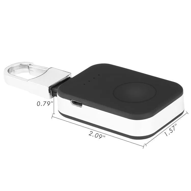 Black Apple Watch keychain power bank with wireless charging pad next to an Apple Watch.