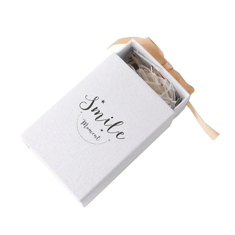 Small cardboard gift box with handbag carrier and raffia trim in blue, pink, red, or white