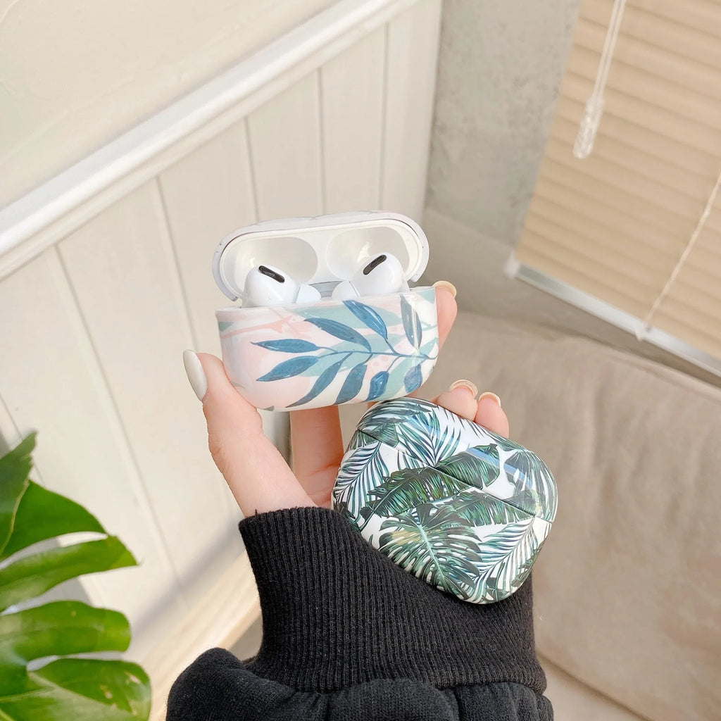 Blue and green tropical banana leaf patterned soft TPU case for Apple AirPods.