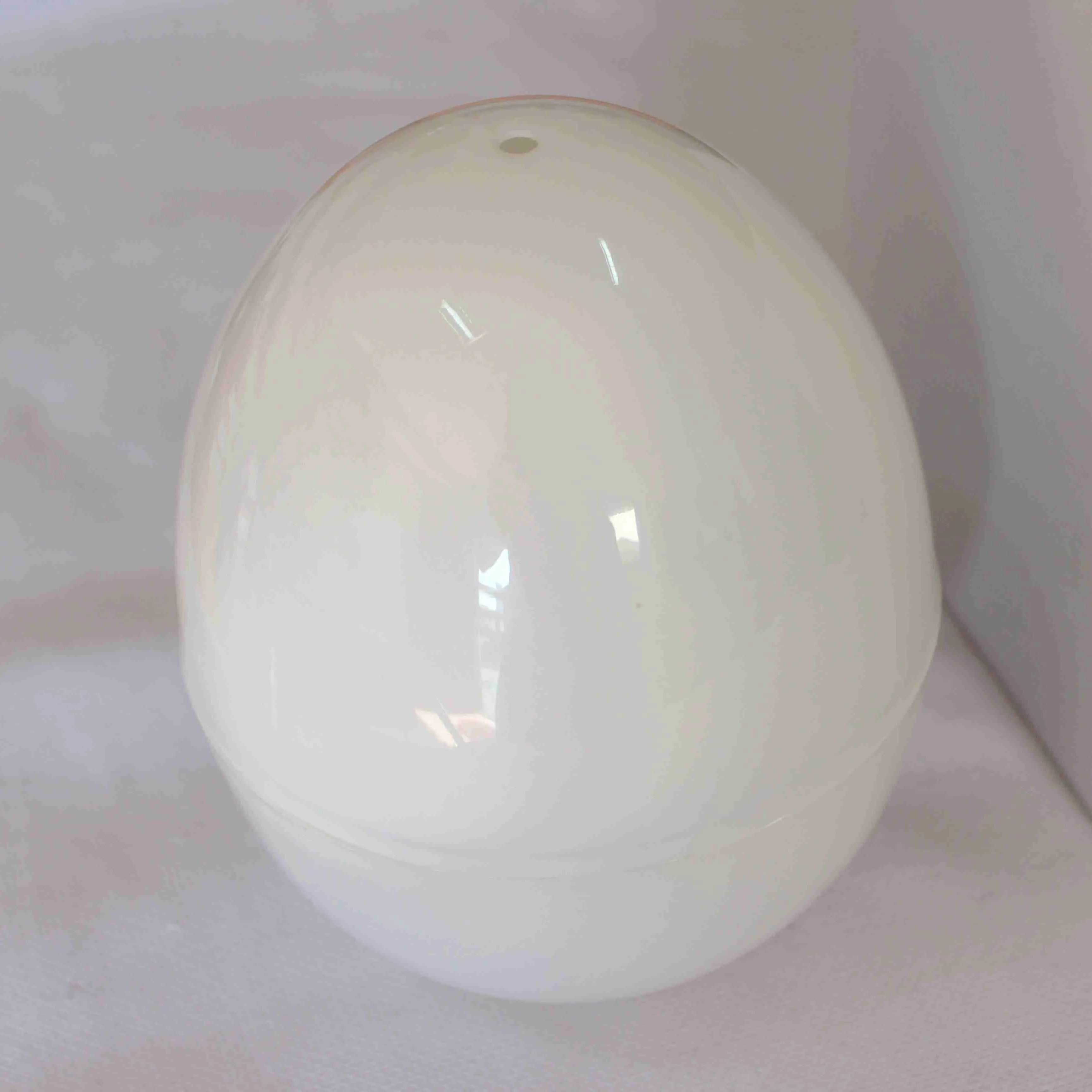 White microwave egg steamer cooker with lid for boiling up to four eggs.