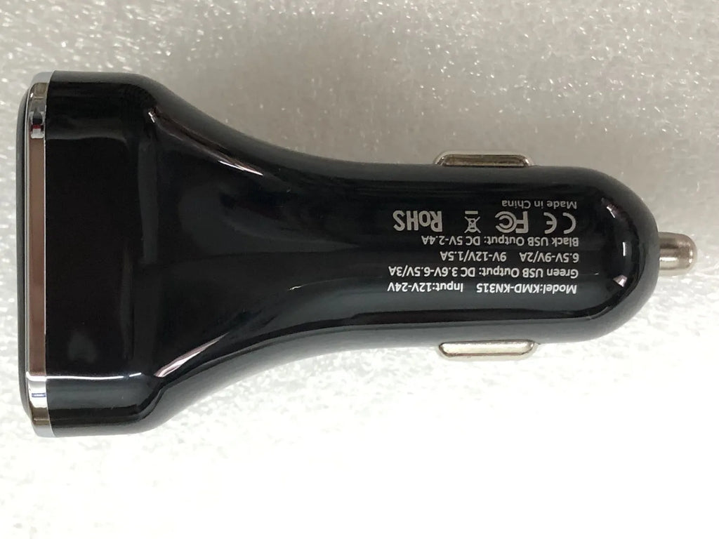 Black dual USB car charger with LCD screen displaying voltage, plugged into a car dashboard socket.