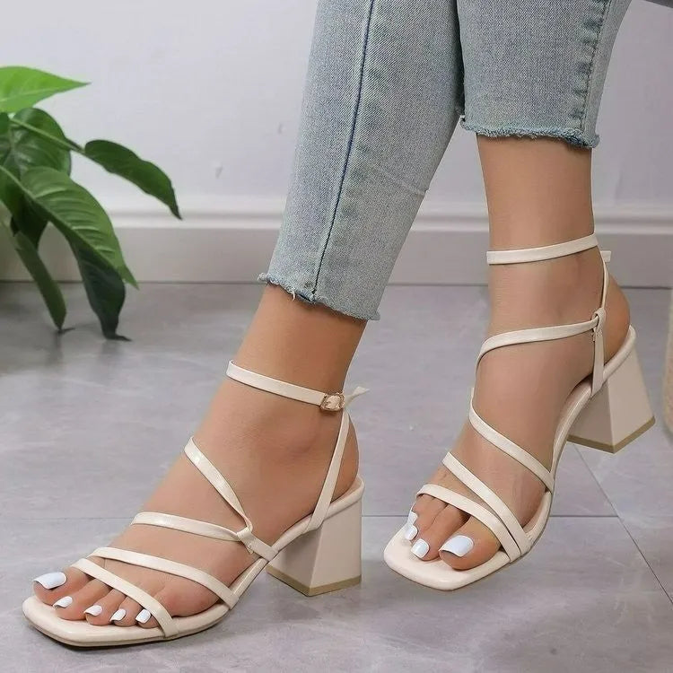 Plus size beige open toe slippers with an adjustable ankle buckle and square toe on a rubber sole.
