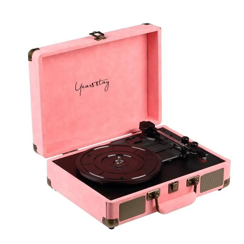 Portable Bluetooth vinyl turntable in a leather carrying case shown in multiple colour options
