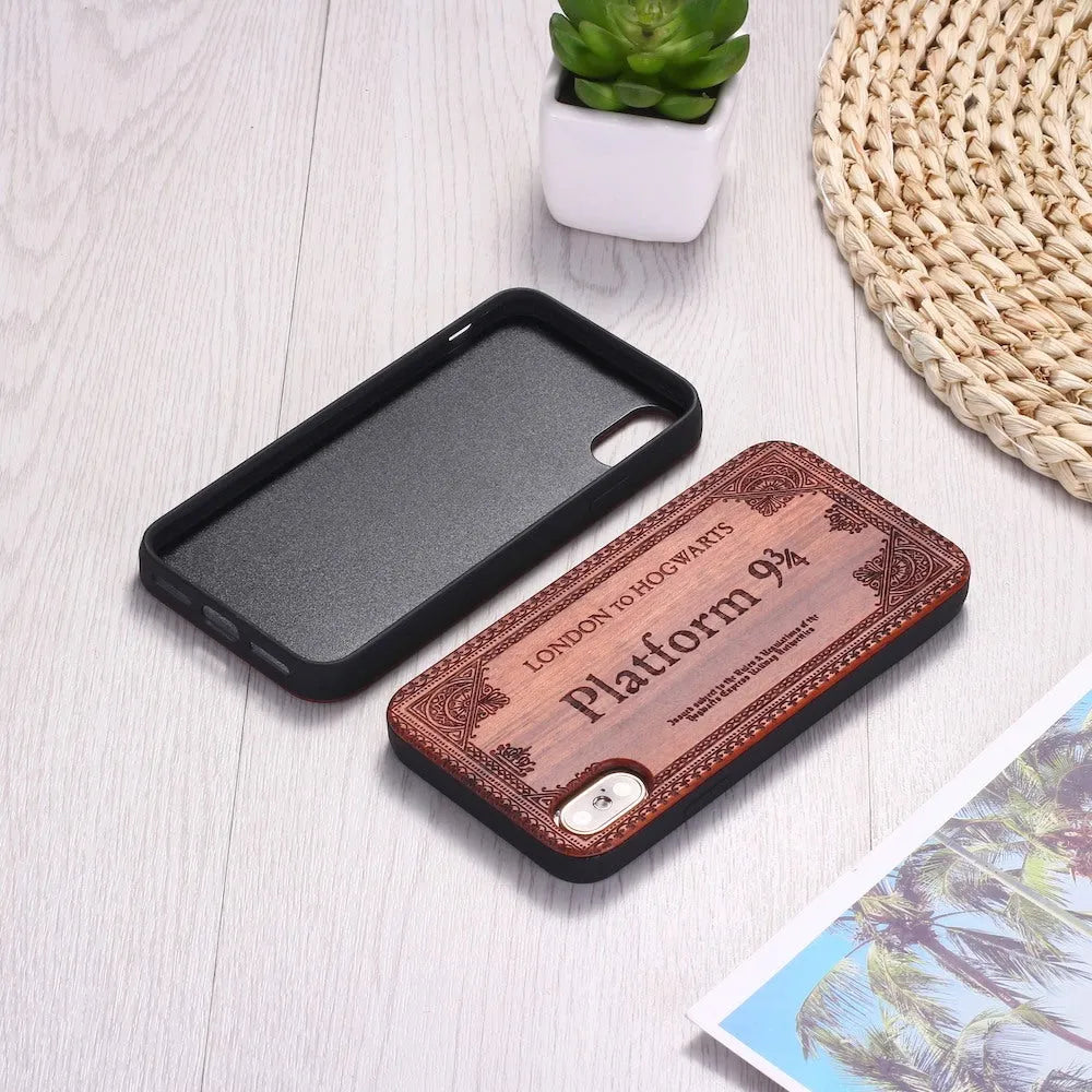 Wooden iPhone case with laser-engraved floral pattern and a black TPU bumper, shown on an iPhone.
