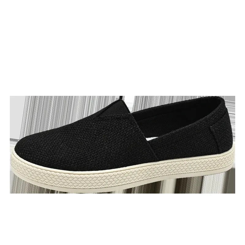 Men's beige canvas slip-on shoes with round toe and PVC sole on neutral background