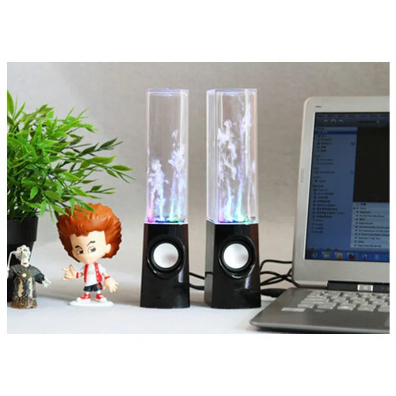 Wireless dancing water speaker with LED light fountain showing colourful water column and dual speakers on a desk