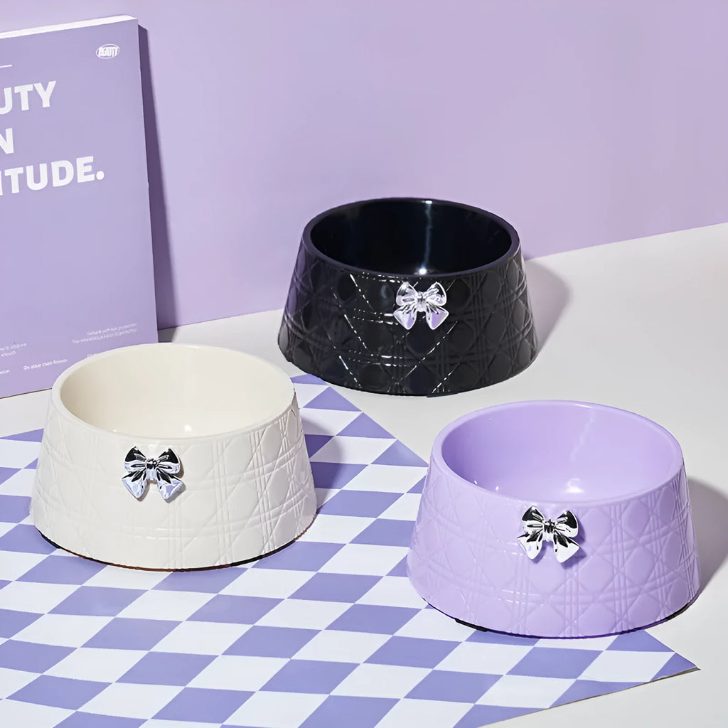 Pet food bowl with diamond pattern and bowknot decoration in black, purple or white with pink or silver bow