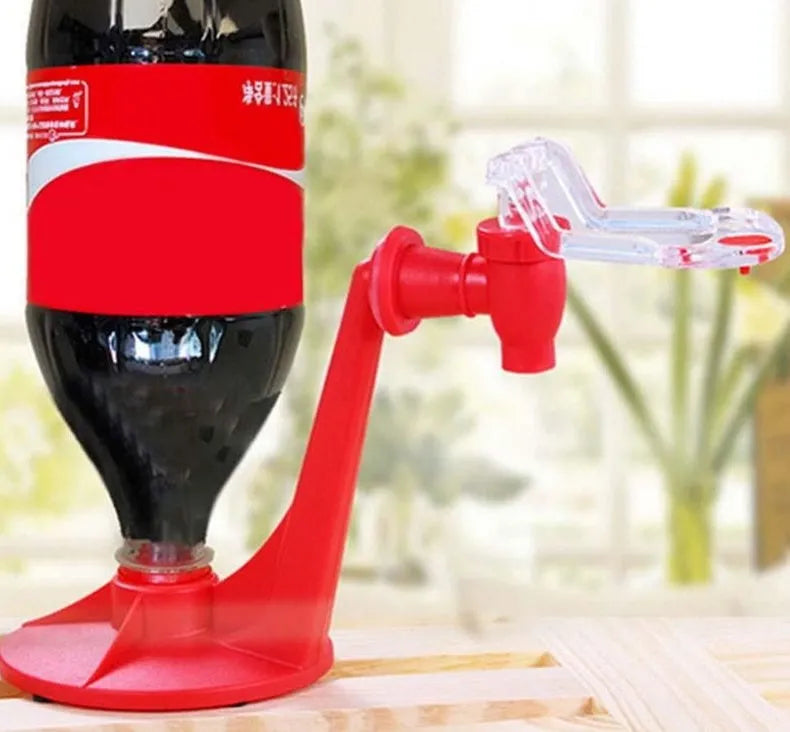 Red plastic Magic Tap soda dispenser attached to 2-liter bottle showing push-in tap mechanism