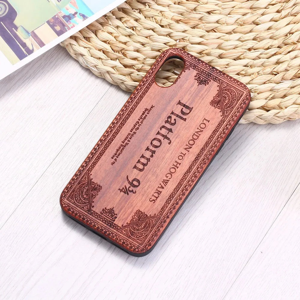 Wooden iPhone case with laser-engraved floral pattern and a black TPU bumper, shown on an iPhone.