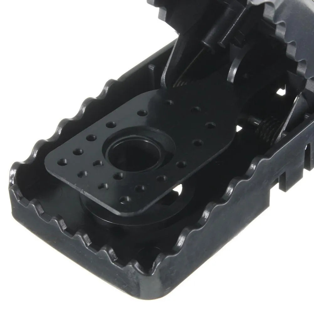 Six black plastic snapping mousetraps showing compact size and smooth surface