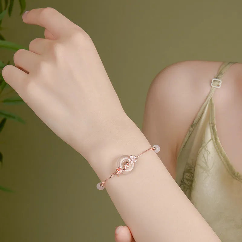 S925 sterling silver bracelet with Chinese flower design and white chalcedony crystal accents featuring koi fish motif