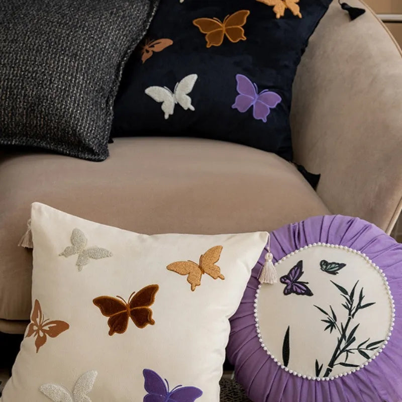 Square beige cushion with embroidered black butterfly pattern in Chinese style.