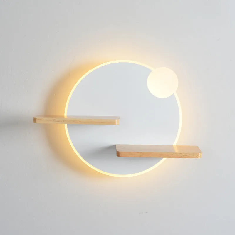 Black round bedside lamp with USB charging port on a wooden nightstand.