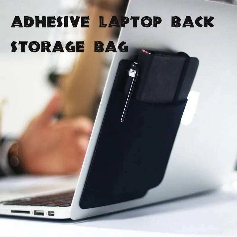 Black adhesive laptop back storage bag attached to a laptop, 15x12 cm, with pen loop and small items inside