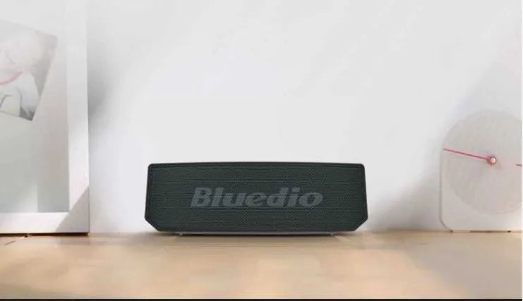 Black cloud smart speaker with compact design and micro-USB port.