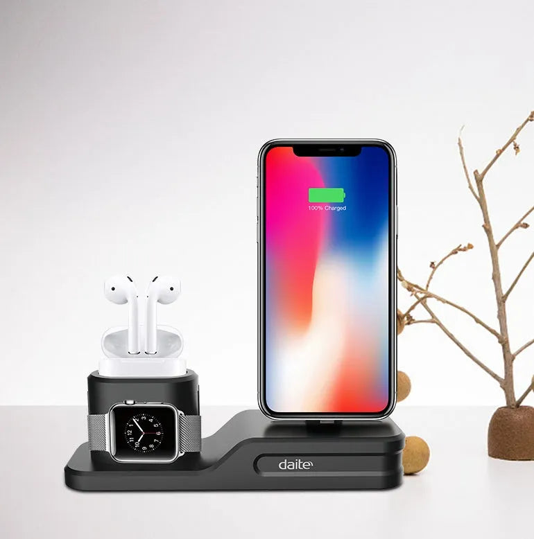 Black silicone 3-in-1 wireless charging station for Apple Watch, AirPods and iPhone on a desk