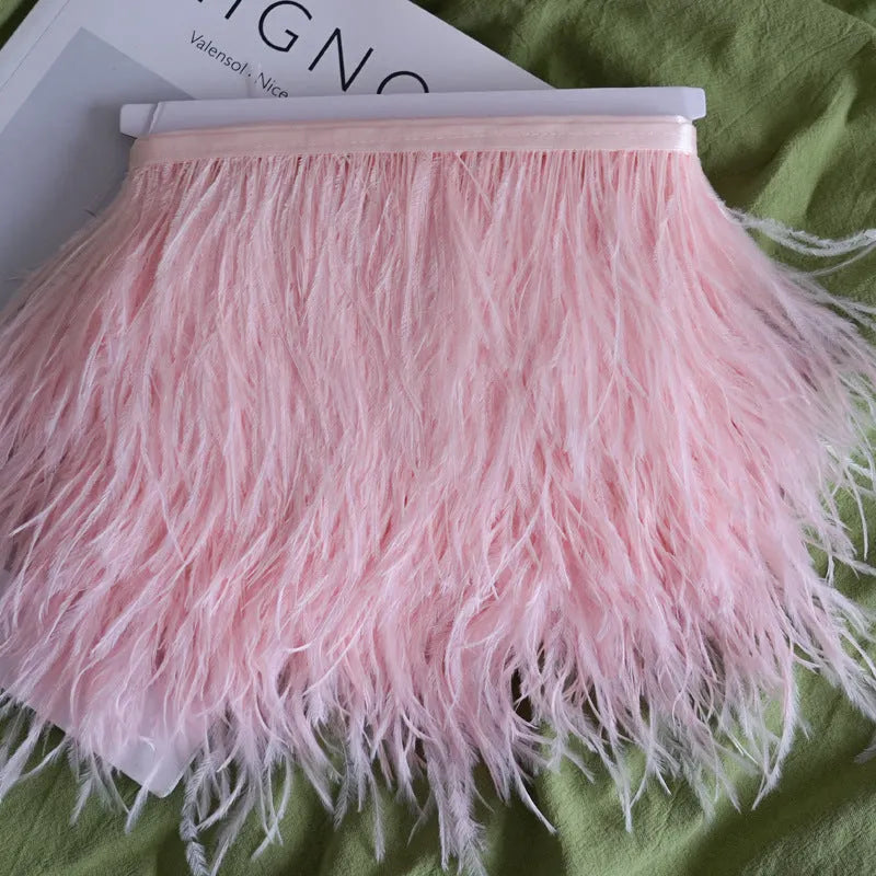 Decorative feather cloth strip in multiple colours including white, black, and mint green for DIY clothing and craft projects