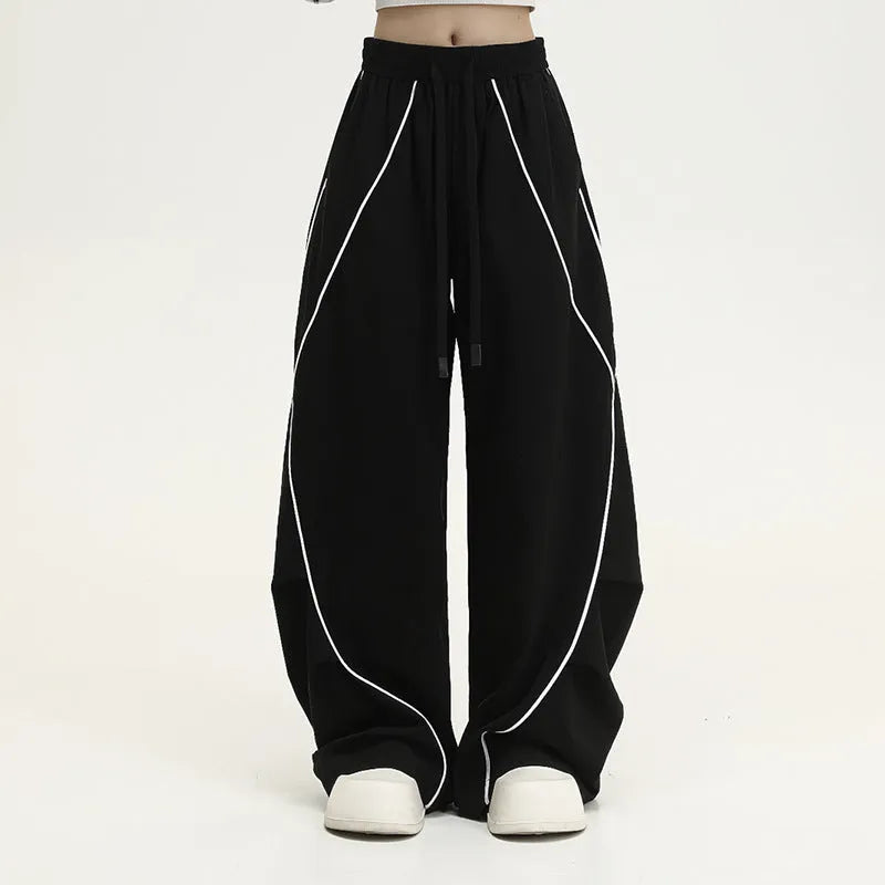 Black pleated wide-leg hip hop sports trousers with striped pattern and elasticated waist.