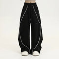 Black pleated wide-leg hip hop sports trousers with striped pattern and elasticated waist.
