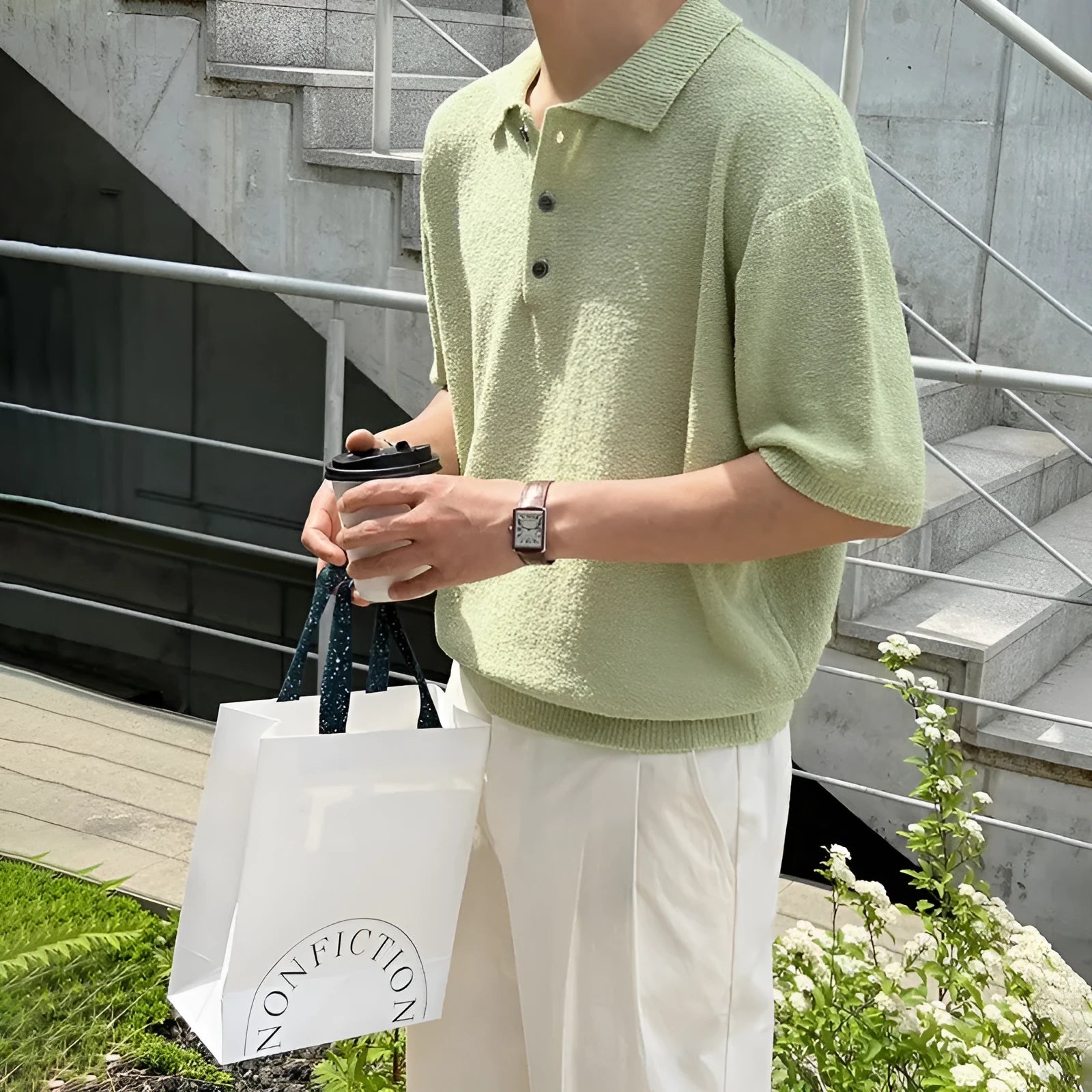 Man modelling a caramel-coloured retro asymmetric knitted polo shirt with short sleeves.