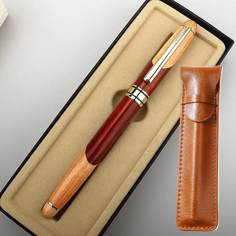 Wooden fountain pen with a metal clip next to a fabric pen bag on a desk.