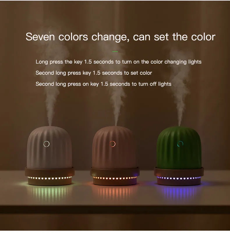 Cactus humidifier night light in green with colourful LED glow on a wooden desk