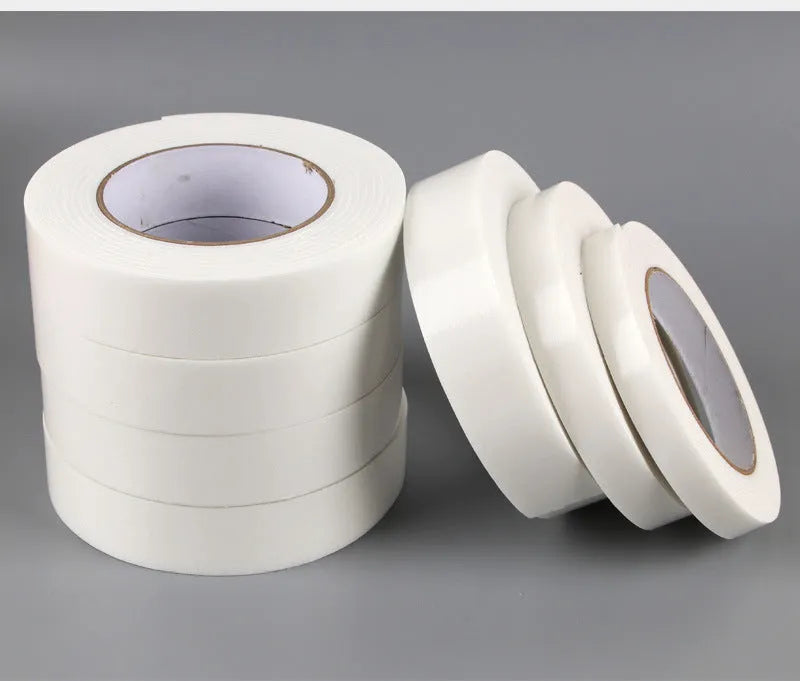 Roll of white foam double-sided adhesive tape showing its 3mm thickness and strong adhesive.