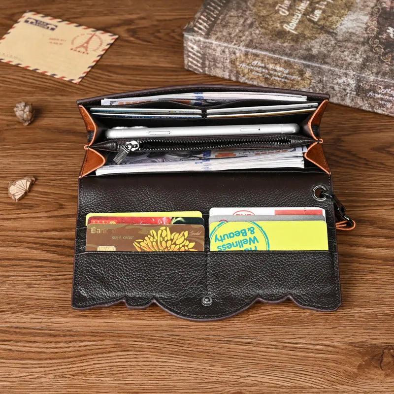 Brown tri-fold leather wallet with deep embossed floral pattern, shown open to reveal card slots and lining.
