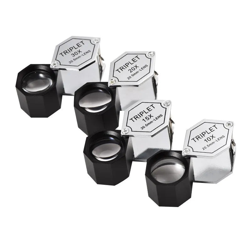 Handheld portable metal magnifying glass with optical glass lens for jewellery and coin identification.