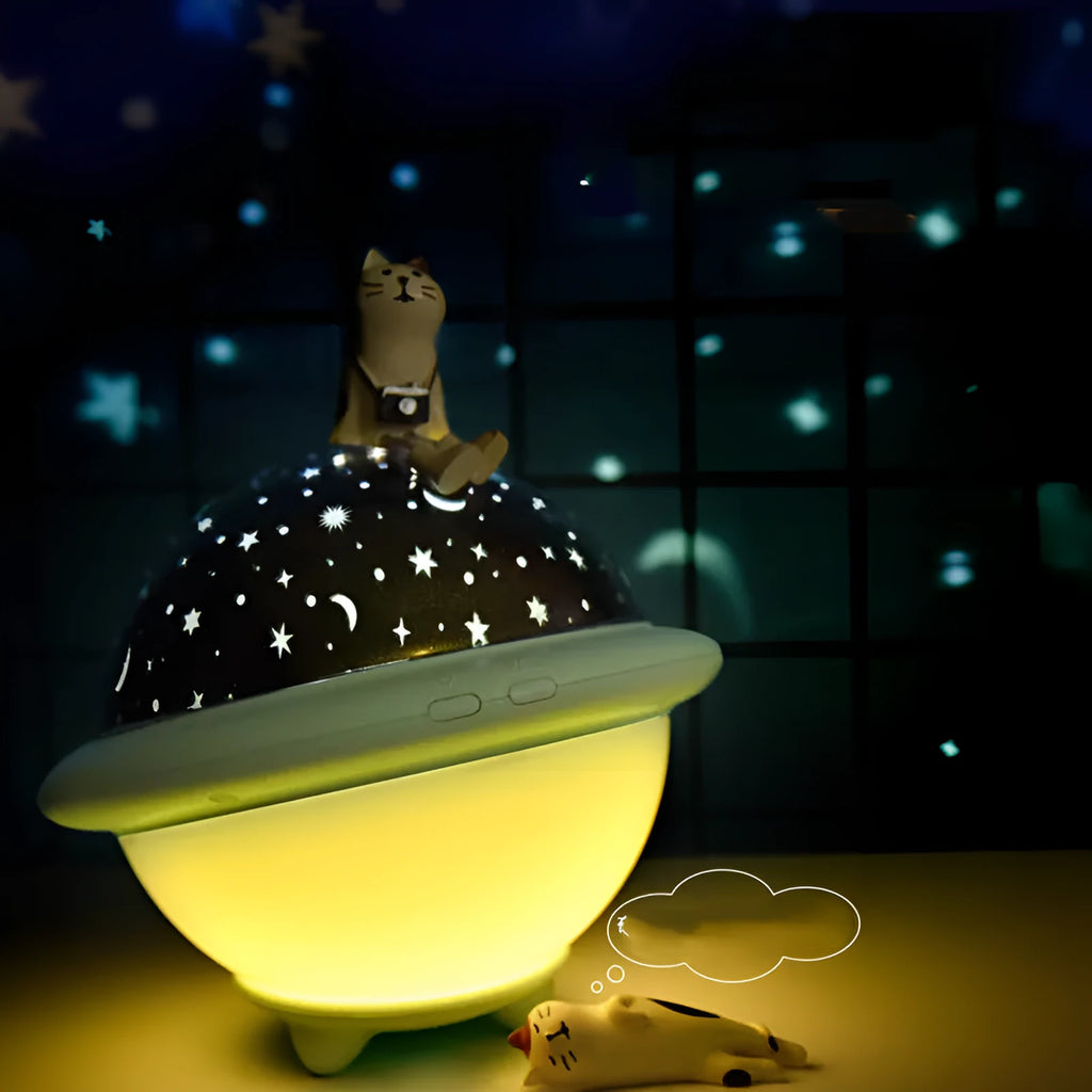 Green UFO-shaped plastic night light projecting a starry sky pattern onto a surface.