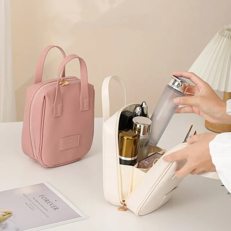 Handle-top cosmetic bag shell-shaped design in cream white with high capacity storage for travel and home use
