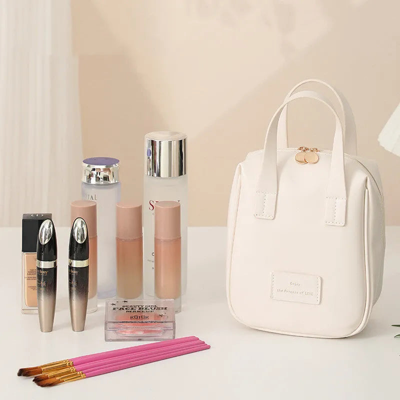 Handle-top cosmetic bag shell-shaped design in cream white with high capacity storage for travel and home use